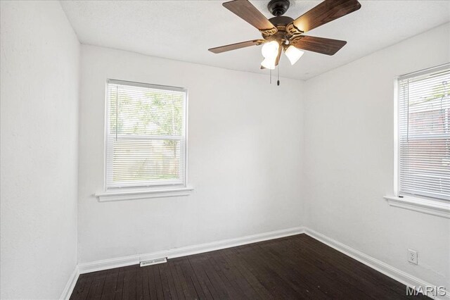 8505 Church Bell Ln, Jennings, MO 63136 - empty room with dark wood finished floors and a ceiling fan