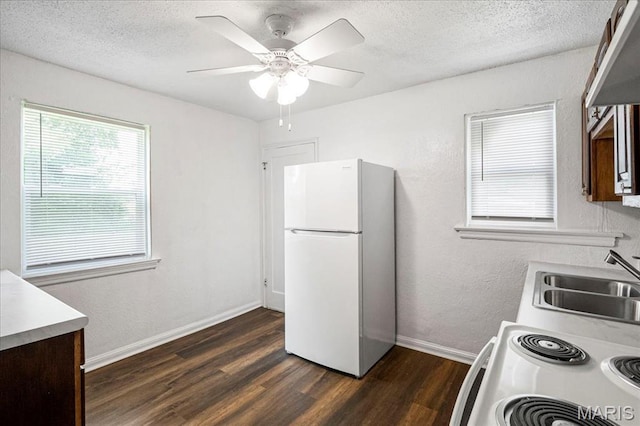 8505 Church Bell Ln, Jennings, MO 63136 - kitchen featuring white appliances, dark wood-style floors, a textured ceiling, a ceiling fan, and light countertops