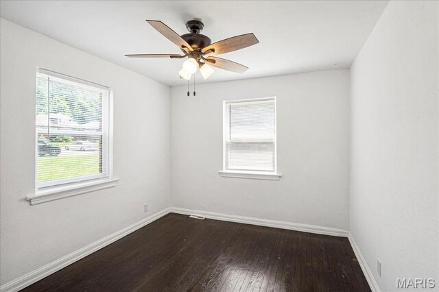 8505 Church Bell Ln, Jennings, MO 63136 - unfurnished room featuring plenty of natural light, dark wood finished floors, and ceiling fan