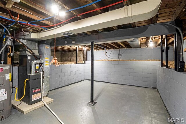 8505 Church Bell Ln, Jennings, MO 63136 - unfinished below grade area featuring electric water heater, heating unit, and concrete block wall