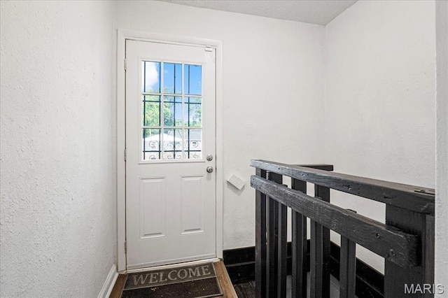 8505 Church Bell Ln, Jennings, MO 63136 - entryway with baseboards and a textured wall