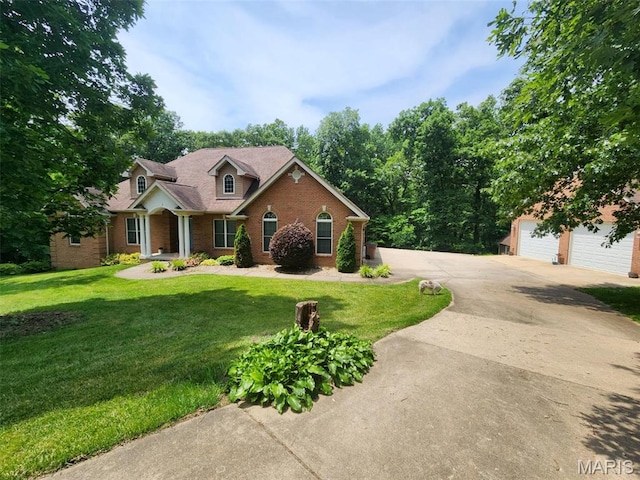 377 Peaceful Hollow Dr, Washington, MO 63090 - traditional-style home featuring brick siding, a front lawn, and a detached garage