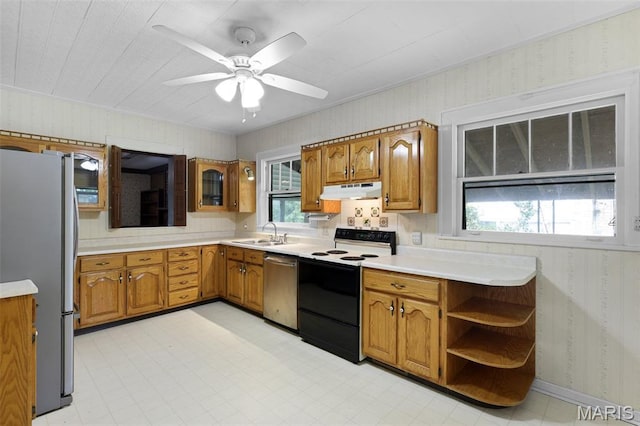 503 E State St, Union, MO 63084 - kitchen with appliances with stainless steel finishes, wallpapered walls, brown cabinets, under cabinet range hood, and light countertops