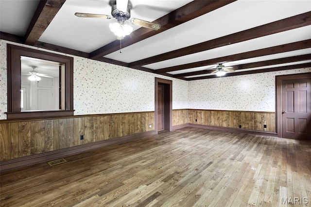 503 E State St, Union, MO 63084 - empty room with a ceiling fan, wainscoting, beam ceiling, hardwood / wood-style flooring, and wallpapered walls