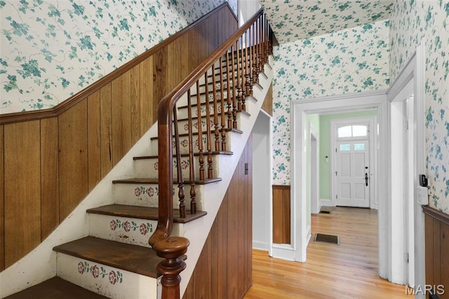 503 E State St, Union, MO 63084 - stairs featuring wallpapered walls, a wainscoted wall, and wood finished floors