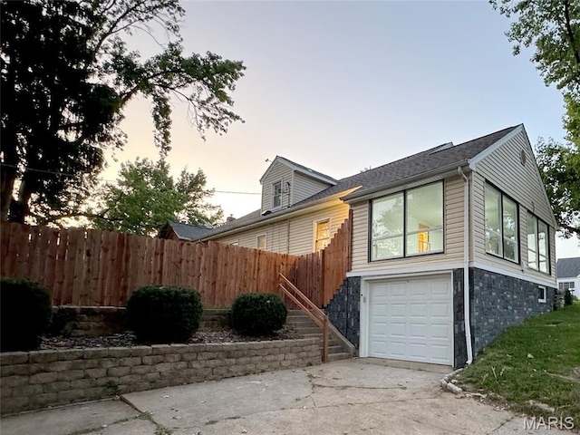 1001 Pike St, Saint Charles, MO 63301 - property exterior at dusk featuring a garage and driveway