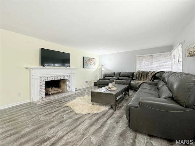 1001 Pike St, Saint Charles, MO 63301 - living room with wood finished floors and a fireplace with flush hearth