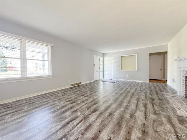 1001 Pike St, Saint Charles, MO 63301 - unfurnished living room with wood finished floors and a fireplace with flush hearth
