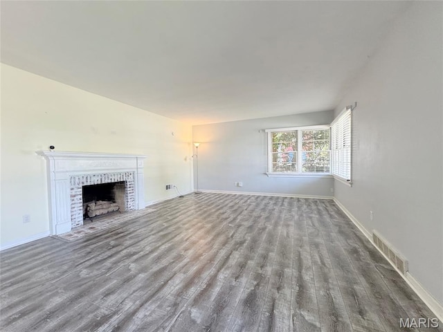 1001 Pike St, Saint Charles, MO 63301 - unfurnished living room featuring wood finished floors and a fireplace with flush hearth