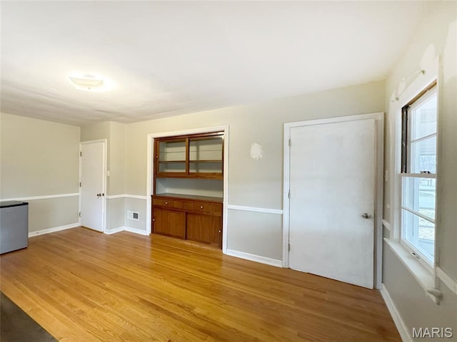 1001 Pike St, Saint Charles, MO 63301 - empty room with wood finished floors and baseboards