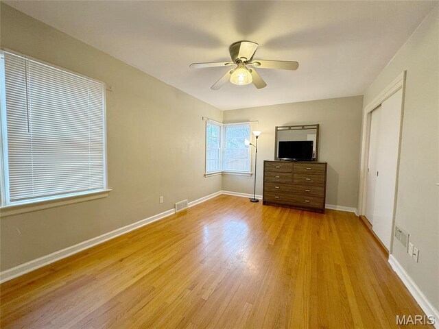 1001 Pike St, Saint Charles, MO 63301 - unfurnished bedroom featuring light wood-style floors, a ceiling fan, and a closet