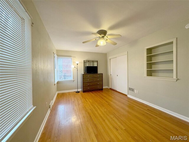1001 Pike St, Saint Charles, MO 63301 - unfurnished bedroom featuring light wood-style flooring, ceiling fan, and a closet