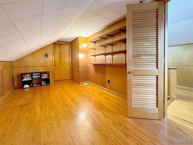 1001 Pike St, Saint Charles, MO 63301 - additional living space with light wood-style floors, lofted ceiling, wood walls, and built in features