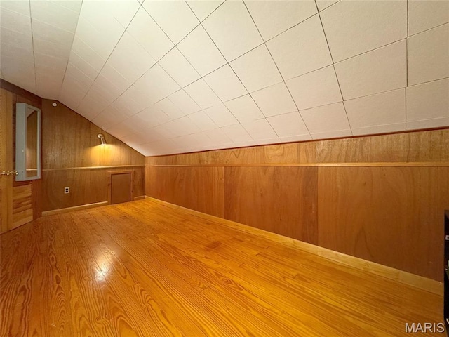1001 Pike St, Saint Charles, MO 63301 - additional living space featuring wood walls, vaulted ceiling, and wood finished floors