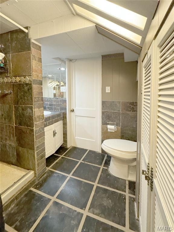 1001 Pike St, Saint Charles, MO 63301 - bathroom featuring tile walls, a stall shower, vanity, and a closet