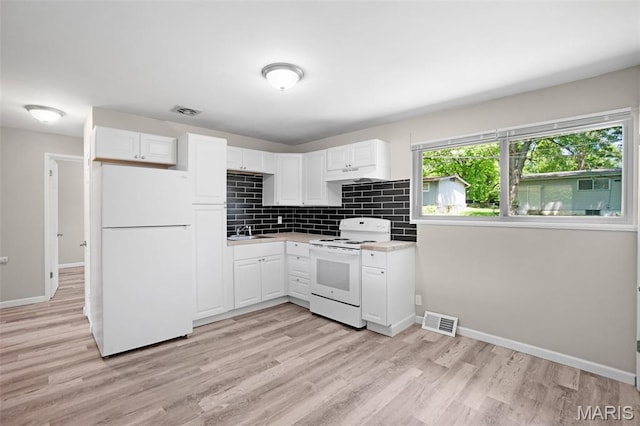 1715 Hudson Rd, Dellwood, MO 63136 - kitchen with white appliances, under cabinet range hood, light countertops, and white cabinetry