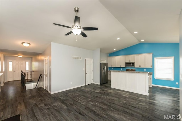 17458 Wyman Ridge Dr, Eureka, MO 63025 - kitchen with stainless steel appliances, vaulted ceiling, white cabinetry, dark wood-style floors, and a center island