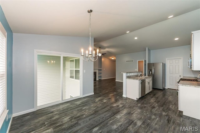 17458 Wyman Ridge Dr, Eureka, MO 63025 - kitchen featuring appliances with stainless steel finishes, open floor plan, a chandelier, dark wood finished floors, and lofted ceiling