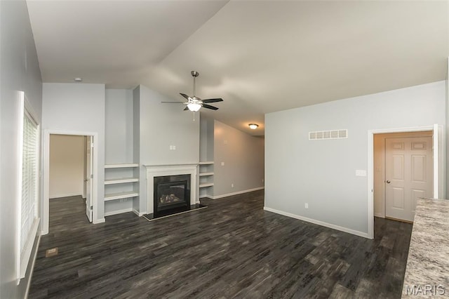 17458 Wyman Ridge Dr, Eureka, MO 63025 - unfurnished living room featuring lofted ceiling, ceiling fan, dark wood-style floors, built in features, and a glass covered fireplace