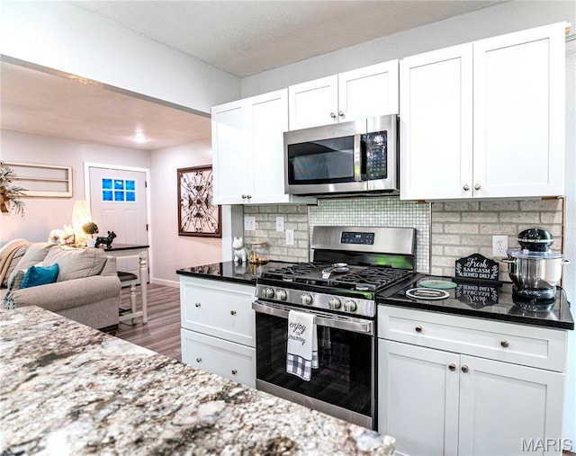 12310 State Route Hh, Rolla, MO 65401 - kitchen with appliances with stainless steel finishes, white cabinetry, and decorative backsplash