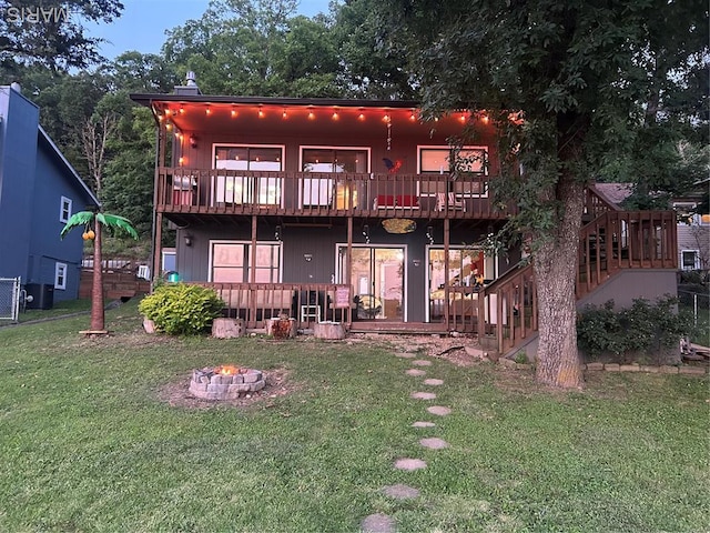 1527 Resorts Rd, Camdenton, MO 65020 - rear view of property featuring an outdoor fire pit, a lawn, a balcony, and a wooden deck