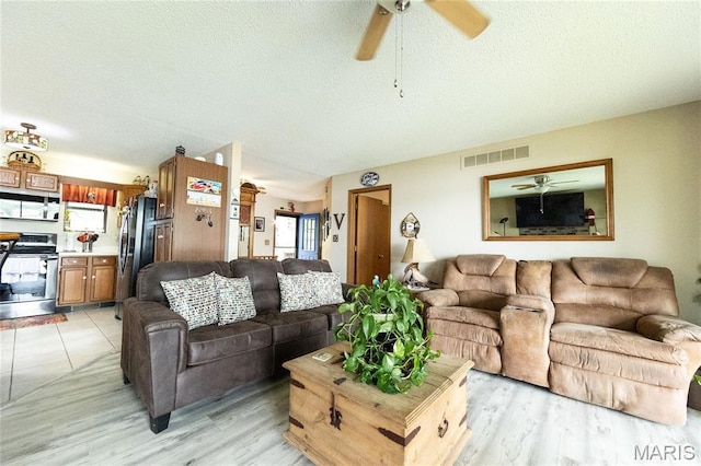 1527 Resorts Rd, Camdenton, MO 65020 - living area featuring a ceiling fan, a textured ceiling, and light wood-type flooring