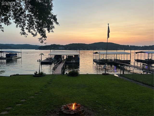 1527 Resorts Rd, Camdenton, MO 65020 - dock area featuring a fire pit, a yard, and a water view