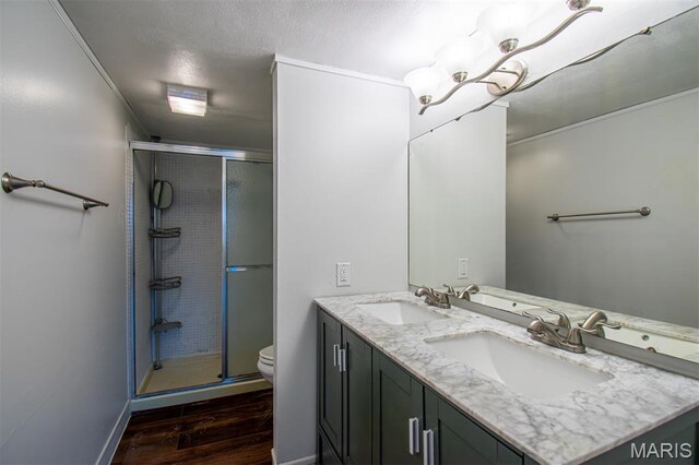 10344 Forest Brook Ln Unit C, Saint Louis, MO 63146 - bathroom with double vanity, a stall shower, wood finished floors, and a textured ceiling