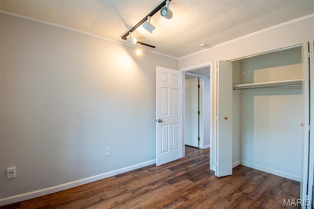 10344 Forest Brook Ln Unit C, Saint Louis, MO 63146 - unfurnished bedroom featuring dark wood-style floors, ornamental molding, rail lighting, and a closet