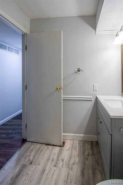 10344 Forest Brook Ln Unit C, Saint Louis, MO 63146 - bathroom featuring wood finished floors and vanity