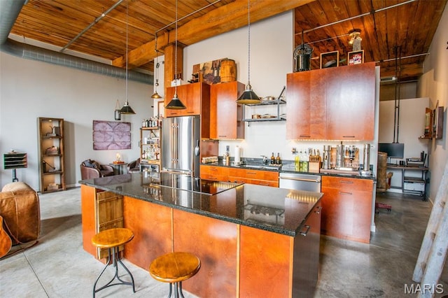 721 17th St Unit 207, Saint Louis, MO 63102 - kitchen featuring stainless steel appliances, finished concrete floors, wooden ceiling, a kitchen island, and a high ceiling