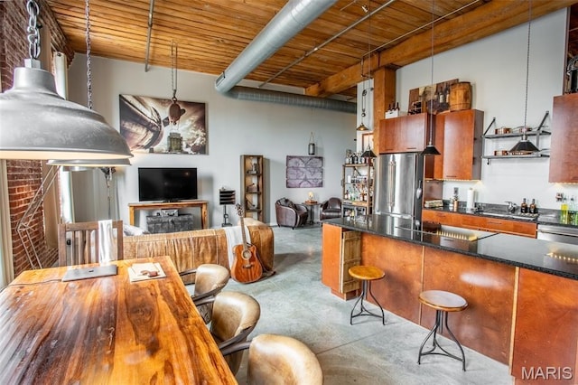 721 17th St Unit 207, Saint Louis, MO 63102 - kitchen featuring a wooden ceiling with exposed beams, stainless steel appliances, finished concrete floors, a kitchen bar, and pendant lighting
