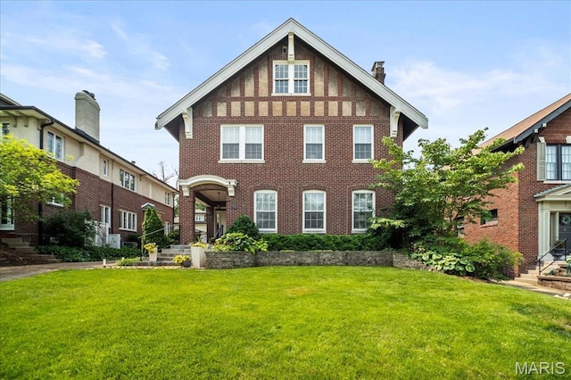 36 Aberdeen Pl, Clayton, MO 63105 - view of front of home featuring a front yard, brick siding, and a chimney