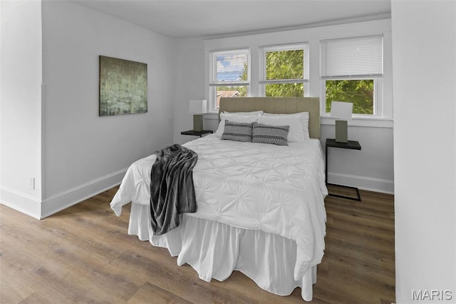1801 Main St, Alton, IL 62002 - bedroom featuring multiple windows and wood finished floors