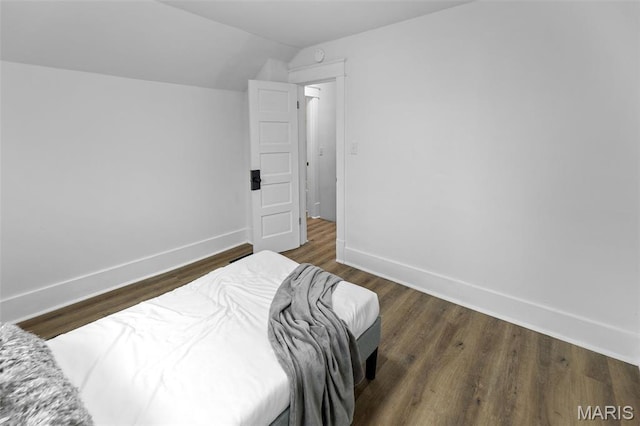 1801 Main St, Alton, IL 62002 - bedroom with lofted ceiling and dark wood finished floors