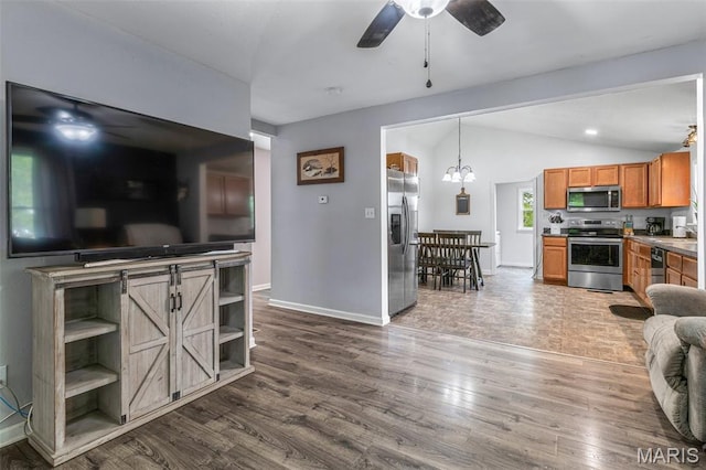 302 Bogy St, De Soto, MO 63020 - living room with a ceiling fan, lofted ceiling, and dark wood-type flooring