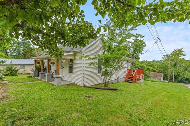 302 Bogy St, De Soto, MO 63020 - back of house featuring a lawn