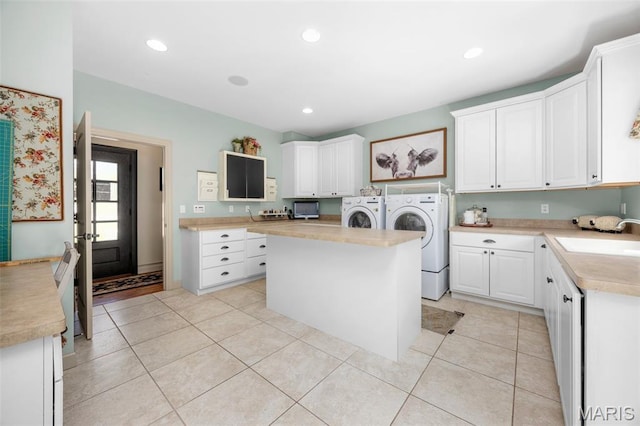701 Crown Pointe Farms, Defiance, MO 63341 - kitchen featuring washing machine and clothes dryer, light countertops, white cabinetry, light tile patterned floors, and recessed lighting
