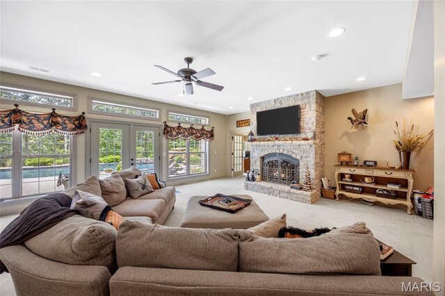 701 Crown Pointe Farms, Defiance, MO 63341 - living area featuring carpet flooring, french doors, a ceiling fan, a stone fireplace, and recessed lighting