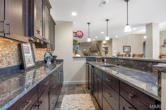 701 Crown Pointe Farms, Defiance, MO 63341 - kitchen featuring backsplash, dark brown cabinetry, glass insert cabinets, pendant lighting, and recessed lighting