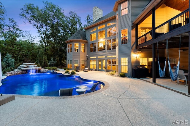 701 Crown Pointe Farms, Defiance, MO 63341 - pool at dusk with a patio, an outdoor pool, and french doors