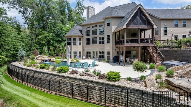 701 Crown Pointe Farms, Defiance, MO 63341 - back of property with stairway, a patio, a chimney, and a wooden deck