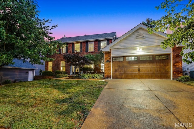 3038 Woodbridge Creek Dr, Saint Louis, MO 63129 - view of front facade with driveway, brick siding, a front yard, and an attached garage