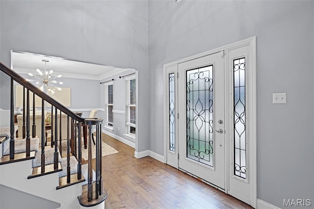 3038 Woodbridge Creek Dr, Saint Louis, MO 63129 - foyer with stairs, ornamental molding, plenty of natural light, wood finished floors, and a chandelier