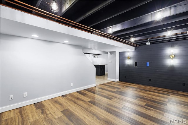 3038 Woodbridge Creek Dr, Saint Louis, MO 63129 - finished basement featuring an accent wall, wood finished floors, wooden walls, and recessed lighting