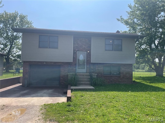 128 Myers St, Licking, MO 65542 - split foyer home featuring brick siding, concrete driveway, an attached garage, a front yard, and entry steps