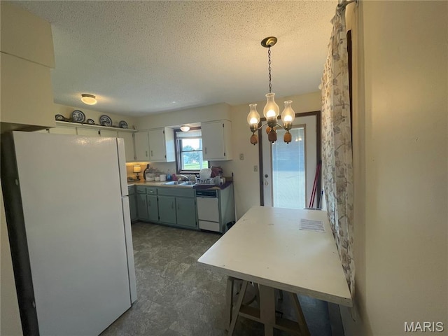 128 Myers St, Licking, MO 65542 - kitchen featuring white appliances, a chandelier, a textured ceiling, white cabinetry, and pendant lighting