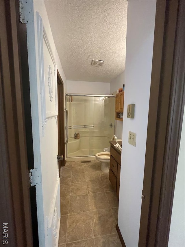 128 Myers St, Licking, MO 65542 - bathroom with a shower with door, vanity, a textured ceiling, and tile patterned floors