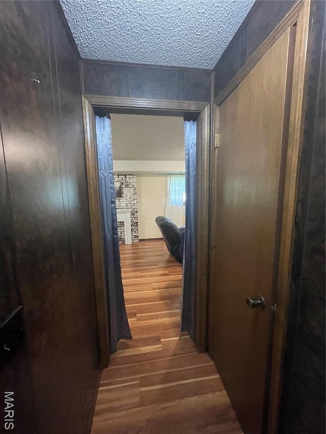 128 Myers St, Licking, MO 65542 - hall featuring wood finished floors and a textured ceiling