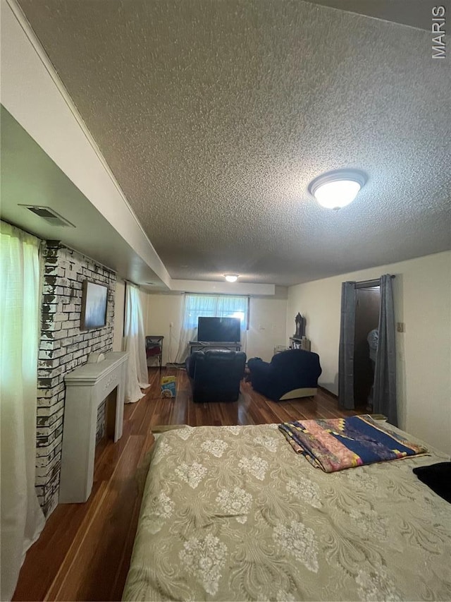 128 Myers St, Licking, MO 65542 - bedroom with a textured ceiling, wood finished floors, and a fireplace
